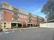 Condo building featuring red brick, balconies, and dedicated parking spaces surrounded by greenery at 560 Dutch Valley Ne Rd # 2301, Atlanta, GA 30324