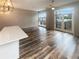 Bright living room with hardwood floors, modern light fixture, and balcony access at 560 Dutch Valley Ne Rd # 2301, Atlanta, GA 30324
