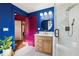 Beautiful bathroom with modern shower, wood vanity, and bold blue walls at 1608 Carroll Nw Dr, Atlanta, GA 30318