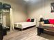 Cozy bedroom furnished with a bed, sofa, closet, and neutral decor at 20 Nw Marietta St # 8D, Atlanta, GA 30303