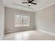 Well lit room, featuring a large window providing ample natural light and a ceiling fan at 928 Flanagan Mill Rd, Auburn, GA 30011