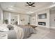 Comfortable bedroom with a tray ceiling, ceiling fan, fireplace and an adjoining living room at 928 Flanagan Mill Rd, Auburn, GA 30011