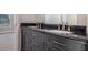 Bathroom vanity with black countertop and double sinks at 11643 Sarah Loop, Hampton, GA 30228
