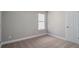 A carpeted bedroom is freshly painted, offering a neutral color palette and ample lighting at 11643 Sarah Loop, Hampton, GA 30228