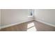 An empty bedroom features neutral walls, white trim, and plush carpeting at 11643 Sarah Loop, Hampton, GA 30228