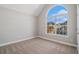 An empty bedroom showcases neutral walls, plush carpet, and a window with neighborhood views at 11643 Sarah Loop, Hampton, GA 30228