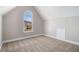 A vacant bedroom featuring neutral walls, plush carpeting, and a large window at 11643 Sarah Loop, Hampton, GA 30228