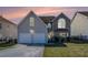 Charming home with a two-car garage, stone accents, and manicured front lawn at 11643 Sarah Loop, Hampton, GA 30228