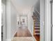Inviting foyer with hardwood floors and staircase leading to the upper level at 11643 Sarah Loop, Hampton, GA 30228