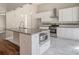 Bright kitchen features granite countertops, a kitchen island, stainless steel appliances and tile flooring at 11643 Sarah Loop, Hampton, GA 30228