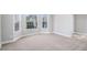 Bright and airy living room with plush carpeting and large windows at 11643 Sarah Loop, Hampton, GA 30228
