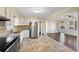 Open-concept kitchen equipped with granite countertops, stainless steel appliances, and tile flooring at 1414 Pierce Se Ave, Smyrna, GA 30080