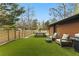 Inviting backyard features lush artificial grass, outdoor seating, a grill, and a privacy fence for relaxation at 1742 Ridgeway Nw Ave, Atlanta, GA 30318