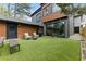 Stylish backyard boasts artificial turf, comfortable seating, a grill, and a sliding glass door to the home at 1742 Ridgeway Nw Ave, Atlanta, GA 30318
