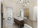 Stylish bathroom featuring a modern sink, integrated mirror, and eye-catching hanging lighting fixtures at 1742 Ridgeway Nw Ave, Atlanta, GA 30318