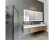 Modern bathroom boasts a wood vanity, backlit mirror, and textured gray tile at 1742 Ridgeway Nw Ave, Atlanta, GA 30318