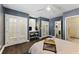 Bright bedroom with wood floors, ceiling fan, and french doors to the ensuite bathroom at 1742 Ridgeway Nw Ave, Atlanta, GA 30318
