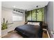Cozy bedroom with a forest wall mural and unique lighting at 1742 Ridgeway Nw Ave, Atlanta, GA 30318