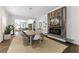 Bright open space with shiplap walls, dining table, fireplace and view into the kitchen creates a welcoming atmosphere at 1742 Ridgeway Nw Ave, Atlanta, GA 30318