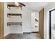 Modern entryway boasts industrial shelving, striking wood accent wall, and tiled floors, creating a unique focal point at 1742 Ridgeway Nw Ave, Atlanta, GA 30318