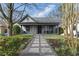 Charming gray cottage-style home with a welcoming front porch and beautifully landscaped front yard at 1742 Ridgeway Nw Ave, Atlanta, GA 30318