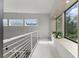 Bright hallway with white railing, light wood floors, and views of trees at 1742 Ridgeway Nw Ave, Atlanta, GA 30318