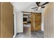 Modern hallway with wood accent walls, tile flooring, and a unique sliding barn door at 1742 Ridgeway Nw Ave, Atlanta, GA 30318