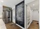 Hallway featuring a large chalkboard wall, stainless steel fridge and glass paneled doors at 1742 Ridgeway Nw Ave, Atlanta, GA 30318