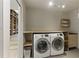 Bright laundry area equipped with modern washer and dryer, built-in shelving, and ample counter space at 1742 Ridgeway Nw Ave, Atlanta, GA 30318