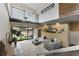 Open concept living room with floor-to-ceiling windows, a gray sofa and access to the backyard at 1742 Ridgeway Nw Ave, Atlanta, GA 30318