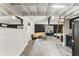 Open living space with whitewashed walls, a tan sofa, and access to a lofted area via ladder at 1742 Ridgeway Nw Ave, Atlanta, GA 30318