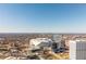 Wide aerial view of a city featuring a stadium, modern skyscrapers, and distant mountain views at 87 Peachtree Sw St # 204, Atlanta, GA 30303