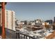 Elevated city view with a metal railing and building tops, capturing a mix of vintage and modern urban architecture at 87 Peachtree Sw St # 204, Atlanta, GA 30303