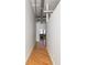 Hallway in unit with wood floors and high ceilings, leading to sitting area and window at 87 Peachtree Sw St # 204, Atlanta, GA 30303