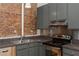 Close up of kitchen featuring stainless appliances, dark cabinets, and granite countertops at 87 Peachtree Sw St # 204, Atlanta, GA 30303