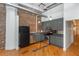 Modern kitchen with stainless appliances, dark cabinets, and exposed brick at 87 Peachtree Sw St # 204, Atlanta, GA 30303