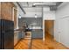 Modern kitchen features stainless steel appliances, gray cabinets, and beautiful hardwood floors at 87 Peachtree Sw St # 204, Atlanta, GA 30303