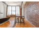 Large window, brick wall and table with stools enhance the main living space with hardwood floors at 87 Peachtree Sw St # 204, Atlanta, GA 30303