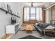 Inviting living room with exposed brick wall, large window, and modern furnishings at 87 Peachtree Sw St # 204, Atlanta, GA 30303