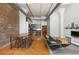 Open-concept floor plan showcasing kitchen, living, and dining areas with exposed brick and hardwood floors at 87 Peachtree Sw St # 204, Atlanta, GA 30303