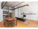 Open-concept living area with exposed brick, modern kitchen, and stylish living room furniture at 87 Peachtree Sw St # 204, Atlanta, GA 30303