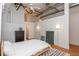 Bright main bedroom with industrial elements, neutral colors, exposed ductwork, and ceiling fan at 87 Peachtree Sw St # 204, Atlanta, GA 30303