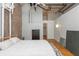 Inviting main bedroom featuring exposed brick and ductwork, wood floors, and large bed at 87 Peachtree Sw St # 204, Atlanta, GA 30303