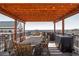 Expansive rooftop deck featuring wooden pergola, dining table, and outdoor grill with city skyline at 87 Peachtree Sw St # 204, Atlanta, GA 30303