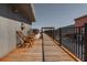 Wooden deck area with wooden chairs and metal railing, with views of the city at 87 Peachtree Sw St # 204, Atlanta, GA 30303