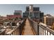 Unique rooftop view featuring a wooden walkway, building equipment, and cityscapes at 87 Peachtree Sw St # 204, Atlanta, GA 30303