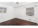 A bright bedroom showcasing hardwood floors and two windows that provide ample natural light at 1496 Greenwillow Dr, Conley, GA 30288