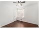 Bright bedroom featuring hardwood floors, a ceiling fan, and a window with a floral curtain at 1496 Greenwillow Dr, Conley, GA 30288