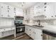 Updated kitchen featuring stainless steel appliances, granite counters, and white cabinetry at 1496 Greenwillow Dr, Conley, GA 30288