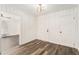 Bright room with wood paneling, vinyl floors, light fixture, and doorways to other rooms at 1496 Greenwillow Dr, Conley, GA 30288